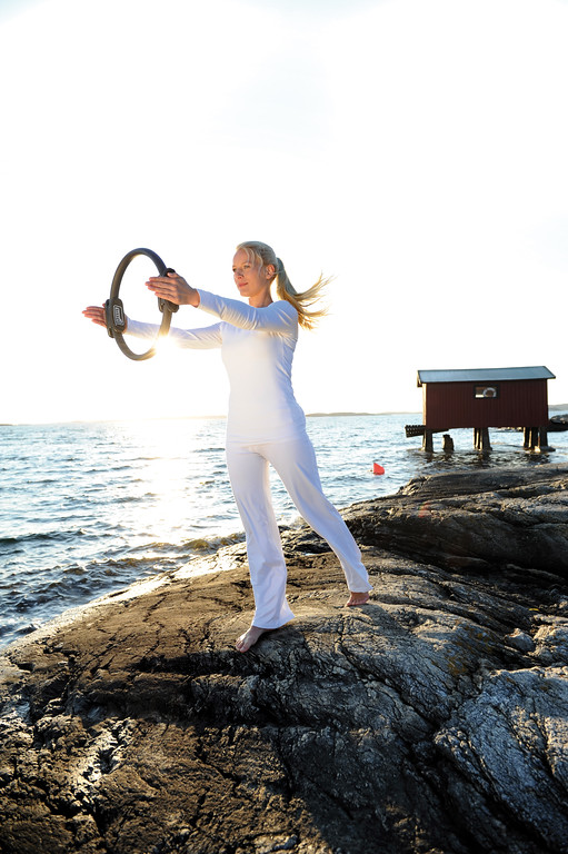 Une femme qui utilise le Pilates Circle en extérieur